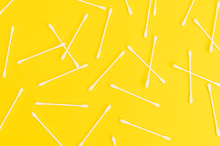 Cotton sticks on a yellow backgroundの写真素材