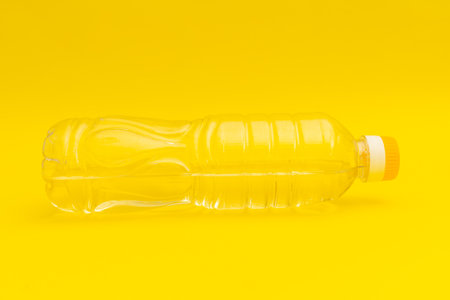 Yellow pasta tongs on yellow background, monochromeの写真素材