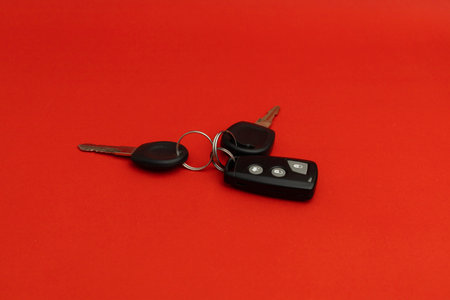 Car keys on red background