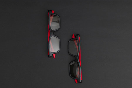Movie glasses black with red ears on a black background