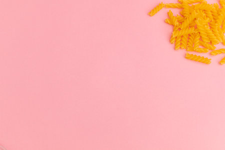 Raw macaroni on pink backgroundの写真素材