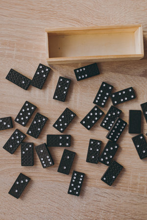 Dominoes in a wooden box on the tableの写真素材