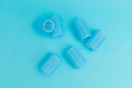 Blue hair curlers on a blue background