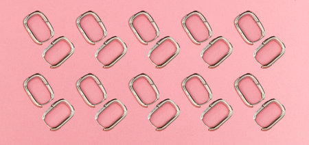 Collage with silver earrings on pink background