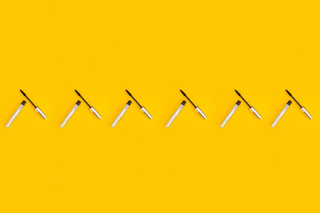 A collage of yellow color with mascara
