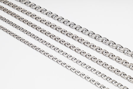 Subject photography of silver chains on a white background