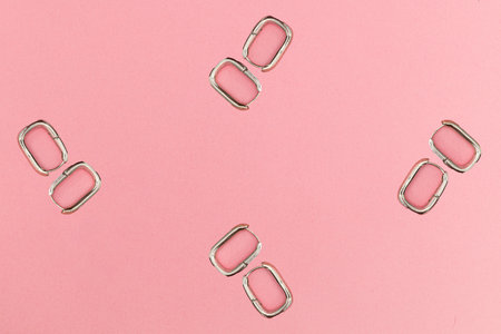 Collage with silver earrings on pink background