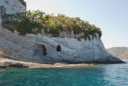 Beautiful rocks of the island of Ponza in Italy in the summer. Caves in the rocks of the island