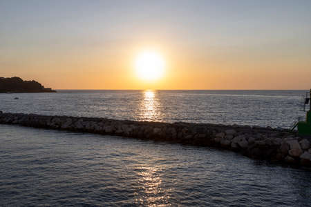 Sunset on the mediterranean sea in summer near the port of Procida, gulf of Naples, Italyのeditorial素材
