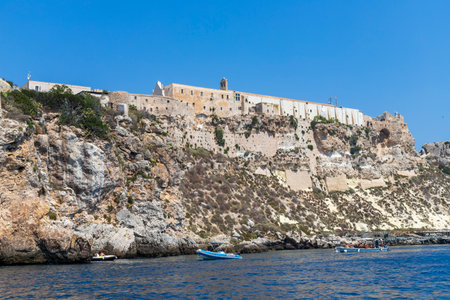 Island of San Nicola in the archipelago of the Tremiti Islands and tourists by boat. Rock with stretches of cliff on the island.の写真素材