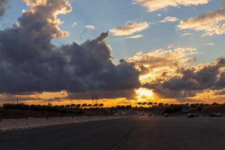 Highway on the outskirts of Rome with few cars, beautiful sunset and sky.