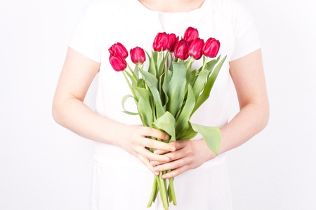 Woman with tilips on a white backgroundの写真素材