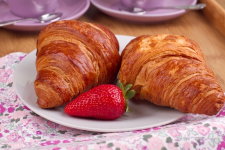 Croissants with strawberry on a plateの写真素材