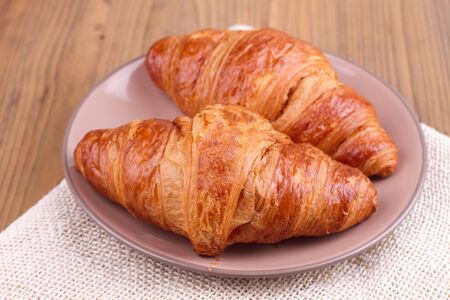 Croissants on a plate serving on a tableの写真素材