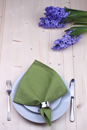 Serving table with napkin and flower on a wooden backgroundの写真素材