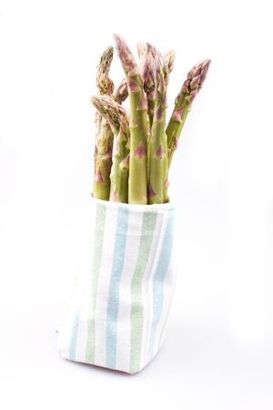 Asparagus in a towel on a white backgroundの写真素材