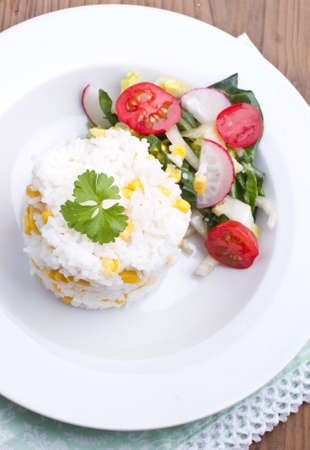 Rice with salad on a plateの写真素材