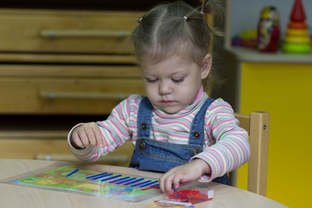 little girl playing with counting sticks on the arithmeticの写真素材