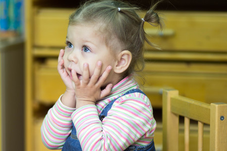little girl playing and studying on lessons in kindergardenの写真素材