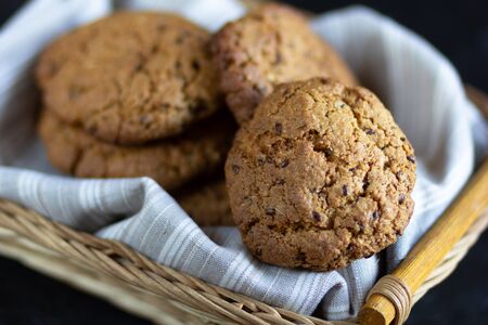 Homemade oatmeal cookies in the basket with linen napkinの写真素材