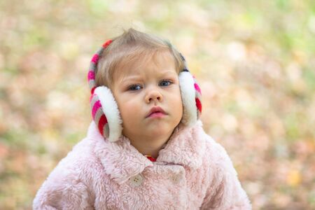 Little girl in the autumn park