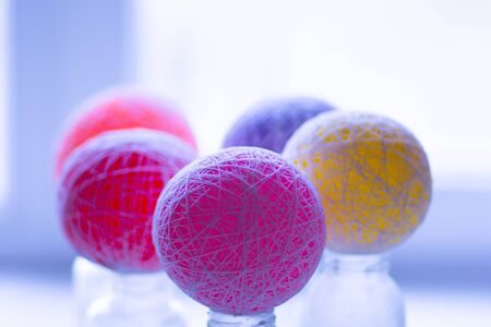 Multicolor balloons drying to become yarn decorative balls
