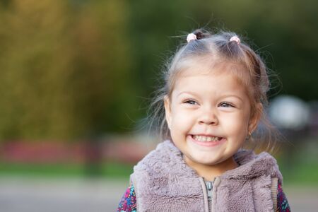 Portrait of smiling little girl looking aside