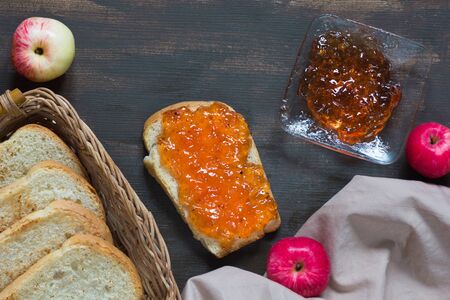 Top view of apple jam on the toast on brown backgroundの写真素材