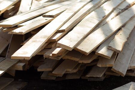 Stack of wooden planks outside