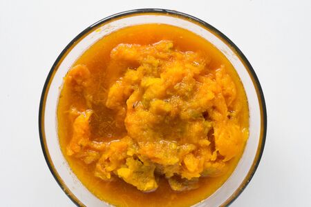 Pumpkin puree in glass bowl on white backgroundの写真素材