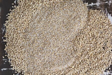 Top view of raw pearl barley and barley groats on wooden backgroundの写真素材