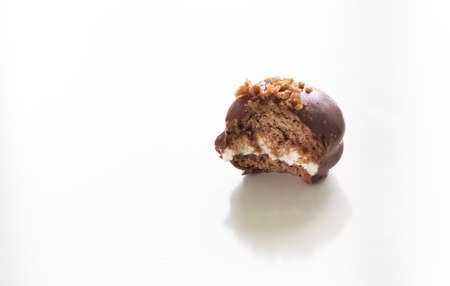 Homemade bitten chocolate pie with crumble on top on white backgroundの写真素材