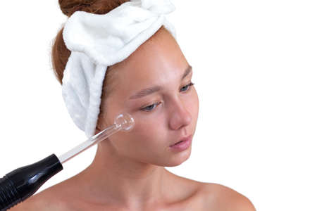 Woman without make up holding darsonval
