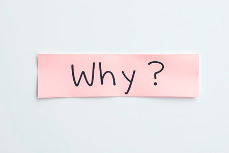 Text Why on pink note on white backgroundの素材