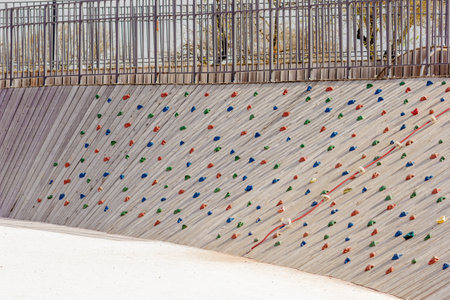 Artificial rock wall on playground in park. High quality photo