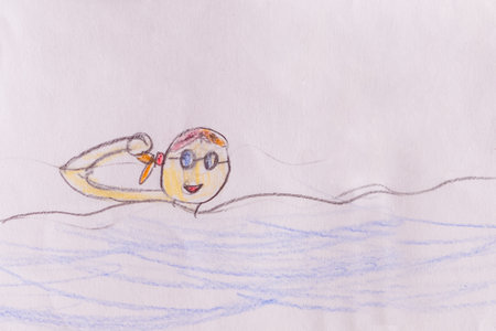 Girl swimming in googles drawn by child using pencils on white paperの写真素材