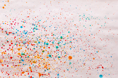 Colored droplets splatters and spots made by child using watercolor painting in naive style as backgroundの写真素材