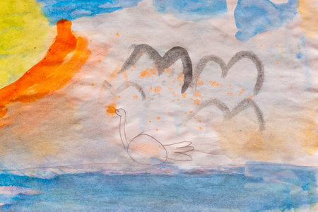 A child's watercolor drawing featuring a swan floating on a lake with a warm sunset and soft blue sky. The artwork has a dreamy, abstract style, blending warm and cool tones.の写真素材
