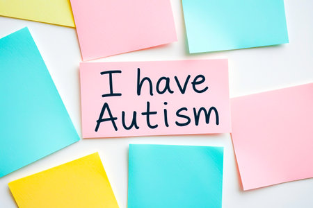 Flat lay of colorful notes with text I have Autism on pink note on white backgroundの素材