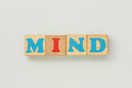 Mind message created with cheerful wooden cubes on white backgroundの写真素材