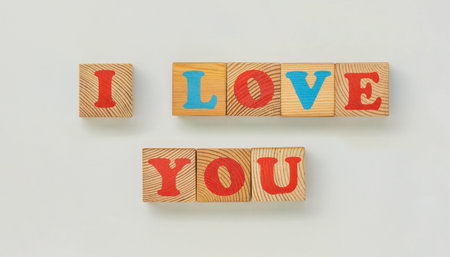 I love you crafted with natural wooden letter blocks on white background