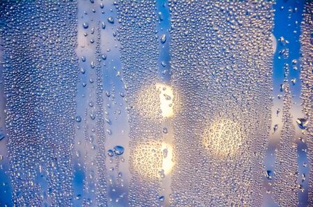 Condenced water drops on a blurred background with lights