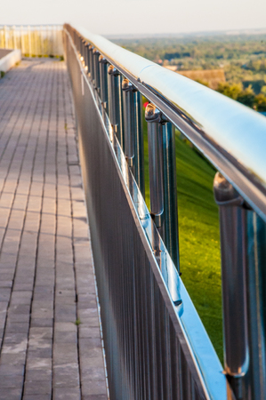 Path with metal railings and covered by gray concrete blocksの写真素材