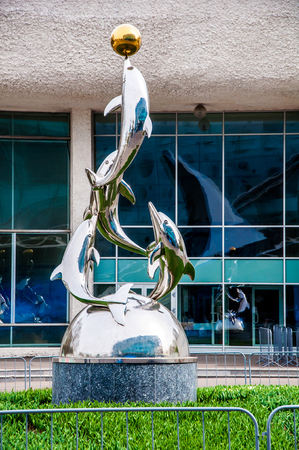 Moscow - May 5, 2017: a sculpture with four playing dolphins holding a golden ball on one's nose near Moskvarium entertainement centerのeditorial素材