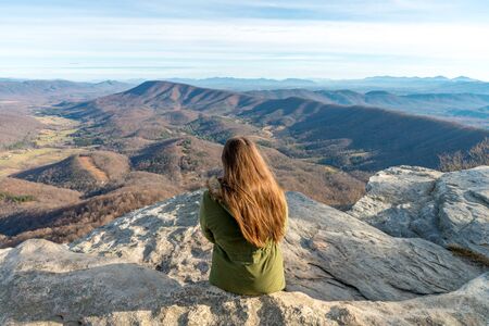 Young woman sitting on the observation point