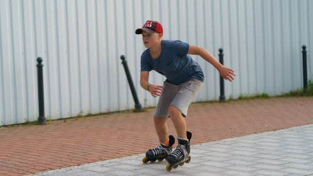 Svetlogorsk, Kaliningrad region, Russia - August 20, 2022: Boy have active sports exercises on the promenade along the sea in summer day. sports weekend. Concept of the healthy lifestyle. Roller skatingのeditorial素材