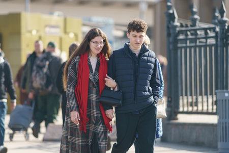 Moscow, Russia - March 28, 2023: Street photography. Youth on the city street in the spring day. Lifestyle concept. Portrait of happy heterosexual couple. Everybody glowing with happiness. Front viewのeditorial素材
