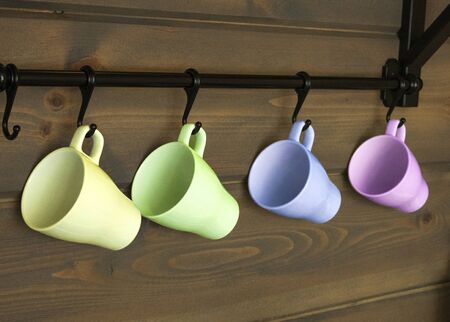 Interior of kitchen in rustic style with vintage kitchen ware and wooden wall. White furniture and wooden decor in bright cottage indoor.の写真素材