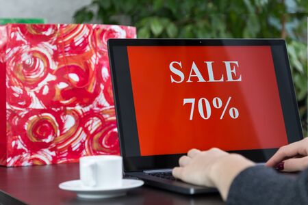 Girl sits at a laptop and makes purchases over the internet.の写真素材