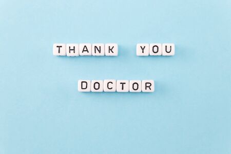 thank you Doctor phrase composed with cubes on blue backgroundの写真素材